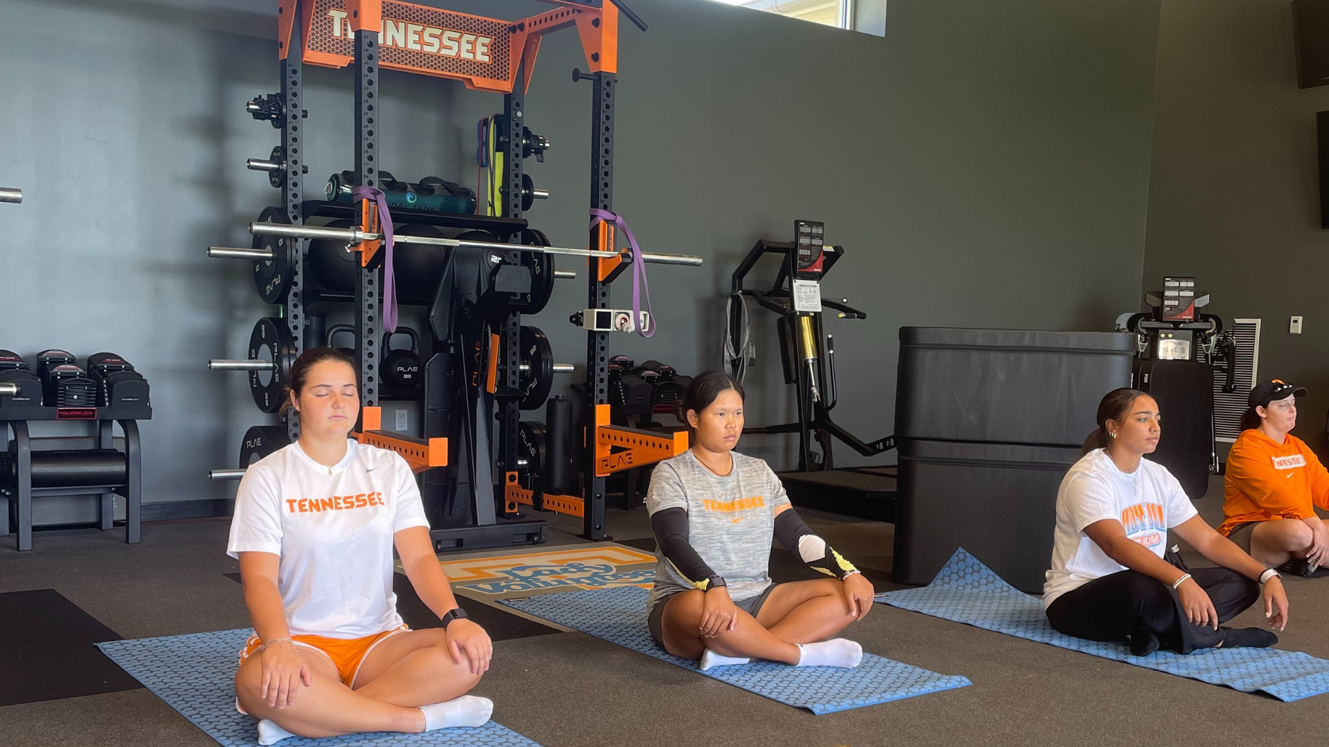 Team sport athletes practicing breath tape training and CO2 tolerance techniques with professional breathing coach